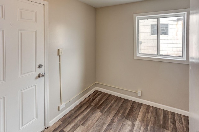 unfurnished room featuring dark wood-type flooring