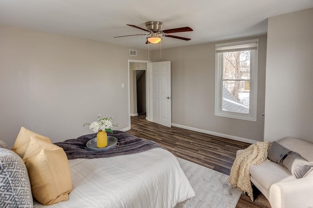 bedroom with ceiling fan and dark hardwood / wood-style flooring