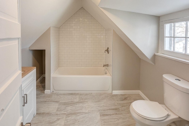 bathroom with toilet, lofted ceiling, and vanity