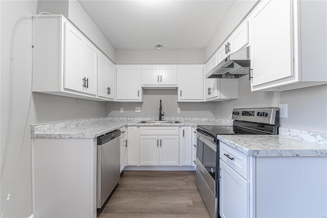 kitchen with white cabinetry, sink, light hardwood / wood-style flooring, and appliances with stainless steel finishes