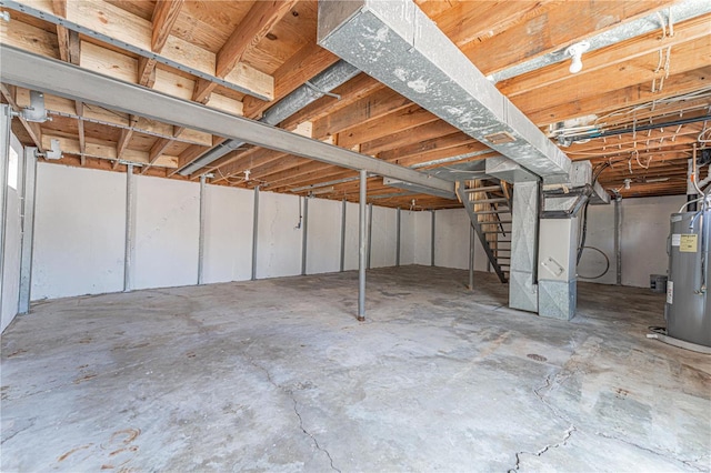 basement featuring heating unit and electric water heater