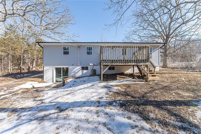 snow covered rear of property featuring a wooden deck