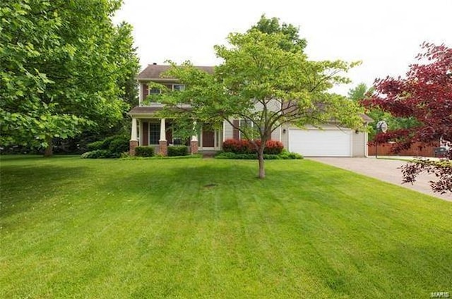 view of front of property featuring a garage and a front lawn