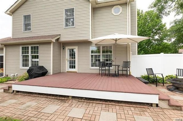 rear view of property featuring a deck