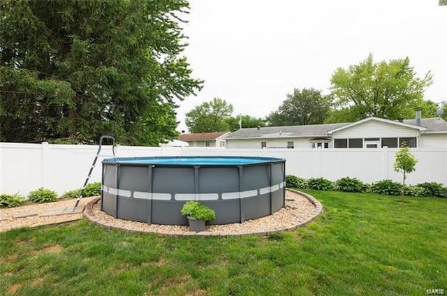 view of swimming pool with a lawn