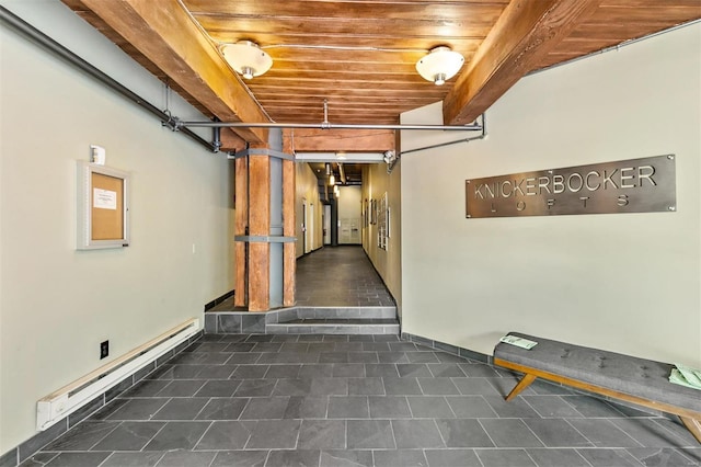 basement featuring a baseboard radiator and wooden ceiling