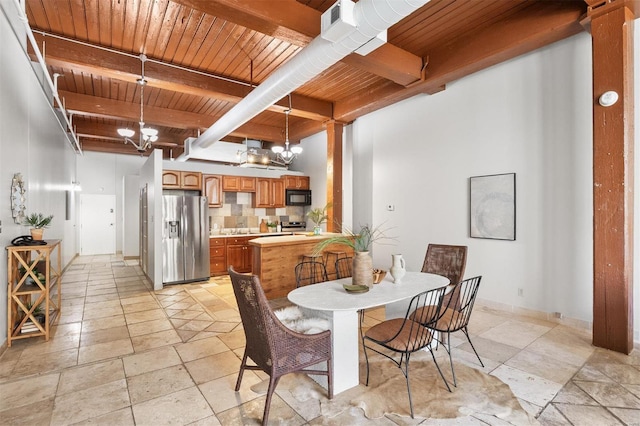 dining area with beamed ceiling, wooden ceiling, and an inviting chandelier