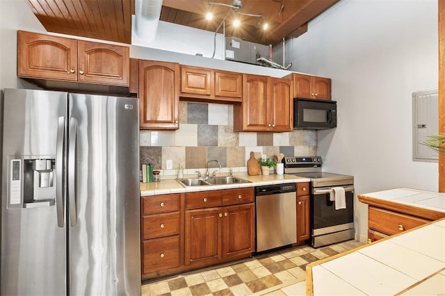 kitchen featuring wood ceiling, tile counters, stainless steel appliances, and sink