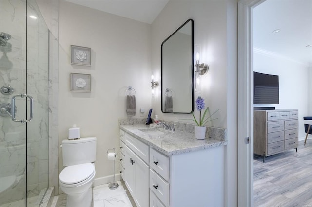 bathroom featuring toilet, a shower with door, and vanity