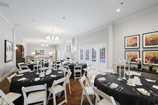 dining room with dark parquet floors, a notable chandelier, and ornamental molding