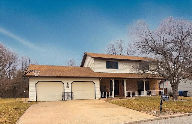 traditional-style house featuring covered porch, driveway, and an attached garage