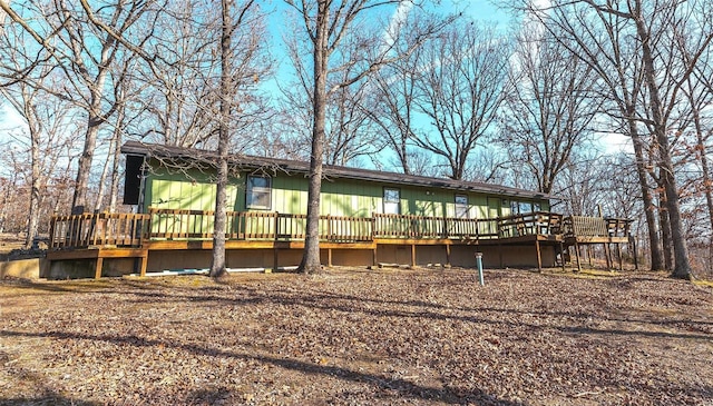 back of house featuring a wooden deck