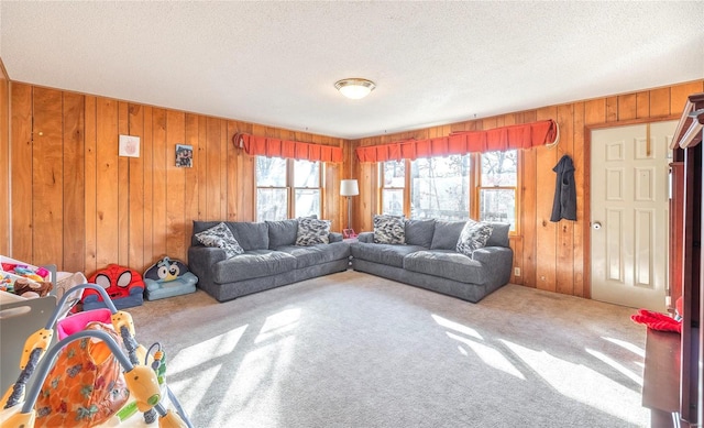 carpeted living room with a textured ceiling and wood walls