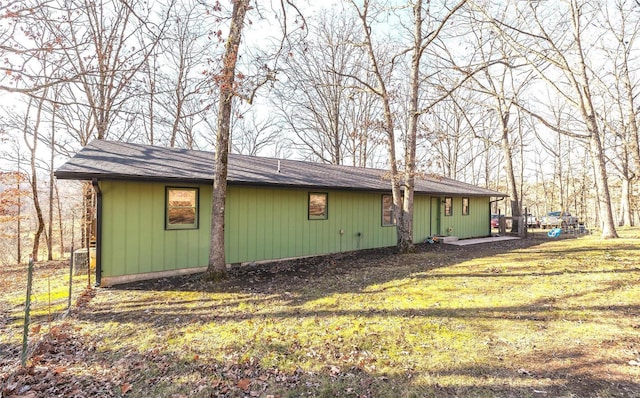 view of side of property with a yard