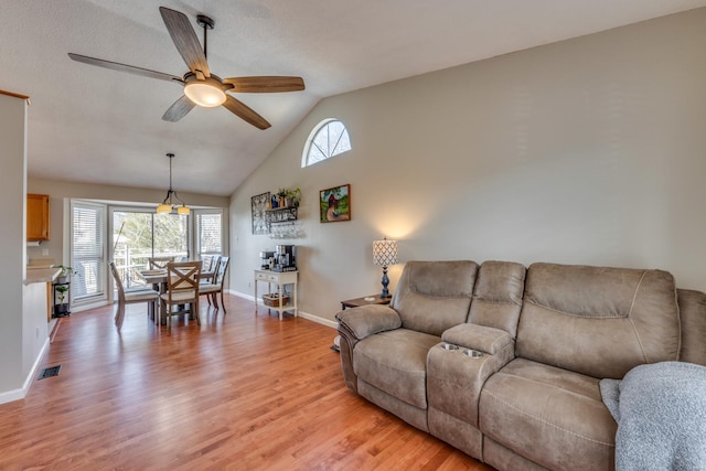 living room with lofted ceiling, a wealth of natural light, light hardwood / wood-style flooring, and ceiling fan