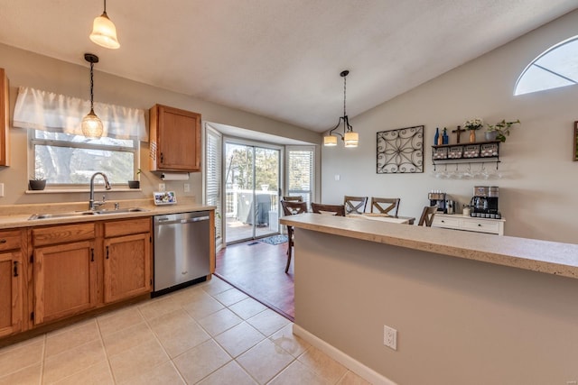 kitchen featuring dishwasher, sink, hanging light fixtures, and a wealth of natural light