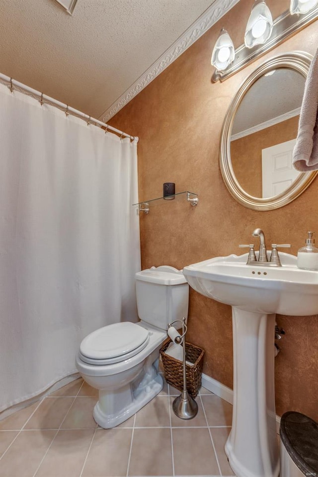 bathroom featuring crown molding, toilet, tile patterned flooring, and a textured ceiling