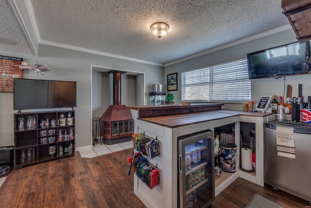 kitchen featuring ornamental molding, light hardwood / wood-style flooring, and a wood stove