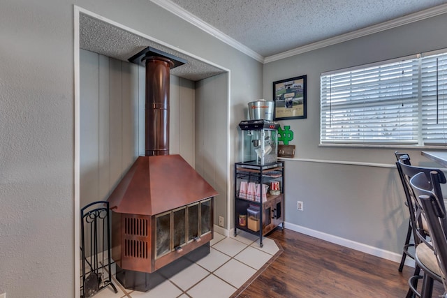 office featuring ornamental molding, a wood stove, hardwood / wood-style floors, and a textured ceiling