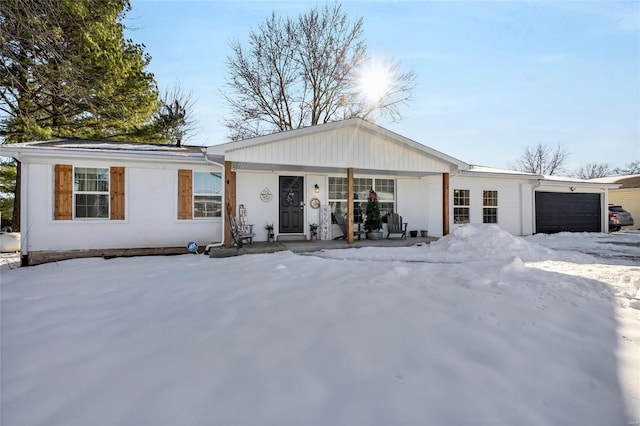 single story home featuring a porch and a garage