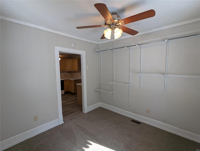 unfurnished bedroom with ceiling fan, carpet floors, and crown molding