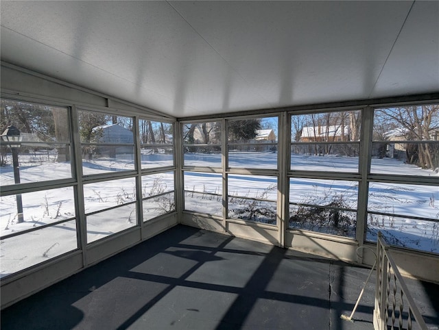 unfurnished sunroom featuring lofted ceiling