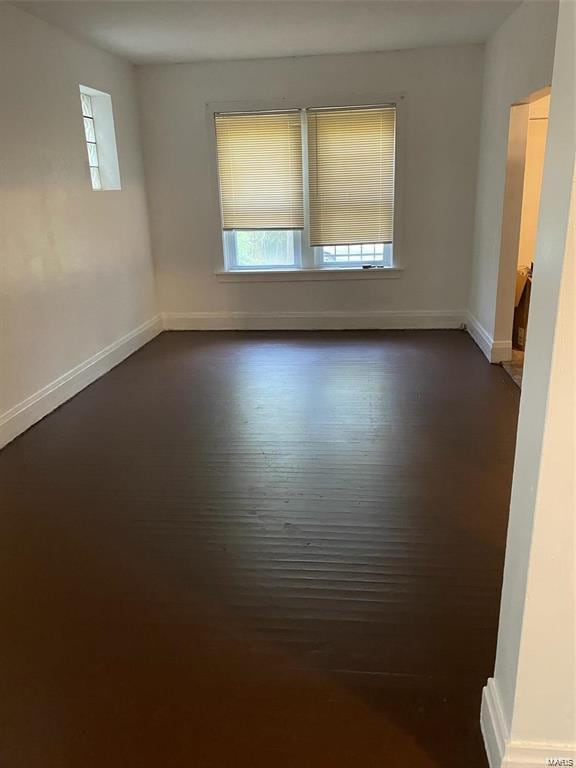 empty room with dark hardwood / wood-style floors