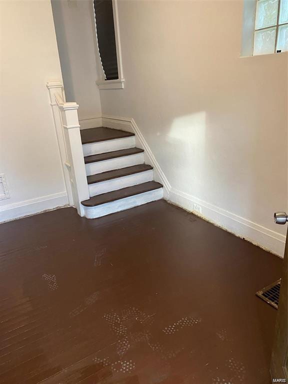 staircase with concrete flooring