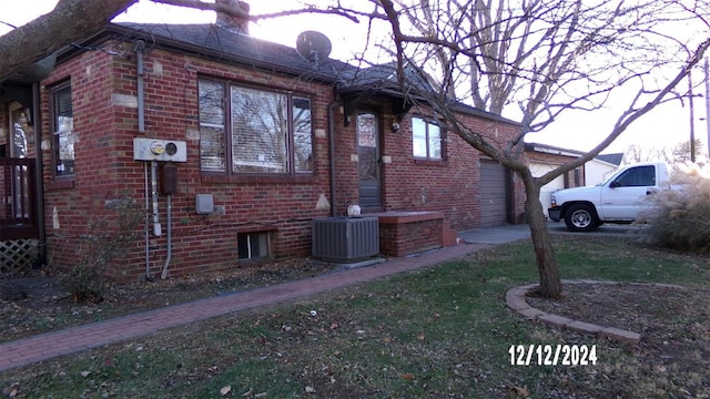 view of side of property featuring central air condition unit