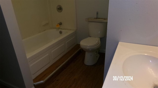 bathroom with hardwood / wood-style flooring, toilet, and sink