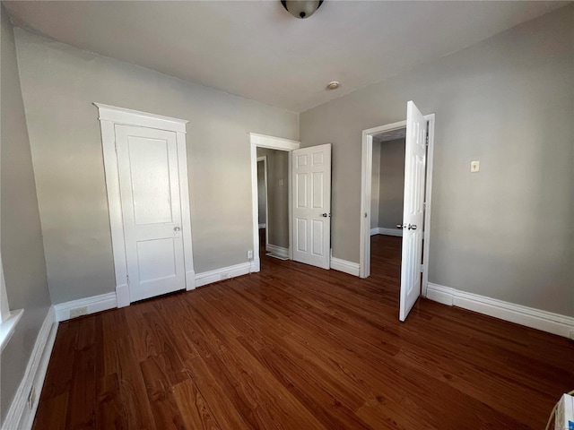 unfurnished bedroom with dark hardwood / wood-style floors