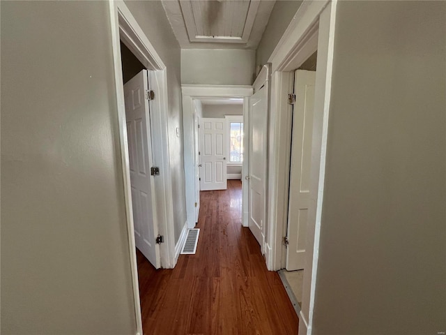 corridor with dark hardwood / wood-style flooring