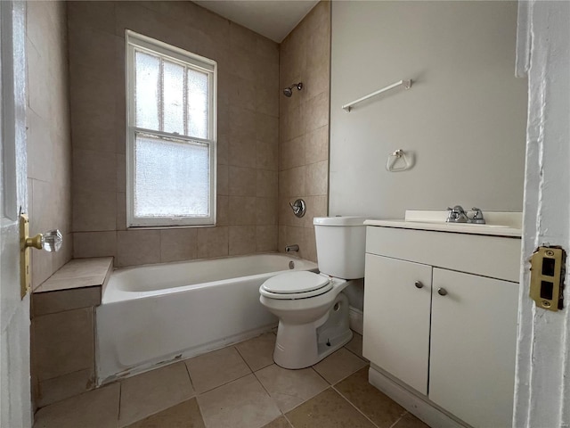 full bathroom with tile patterned floors, vanity, toilet, and tiled shower / bath combo