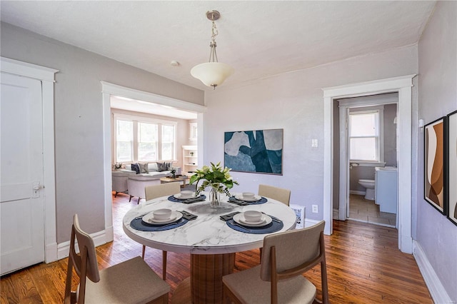 dining area with dark wood-type flooring