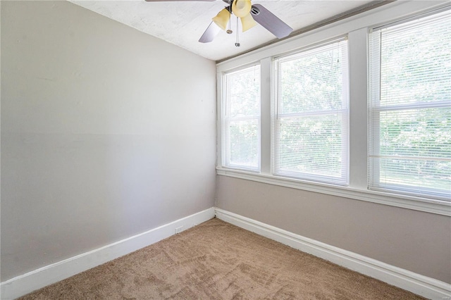 spare room featuring carpet flooring and ceiling fan