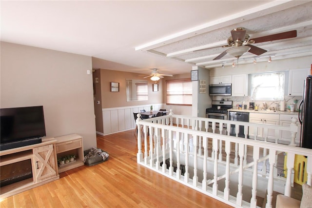 interior space featuring light hardwood / wood-style flooring, ceiling fan, and sink