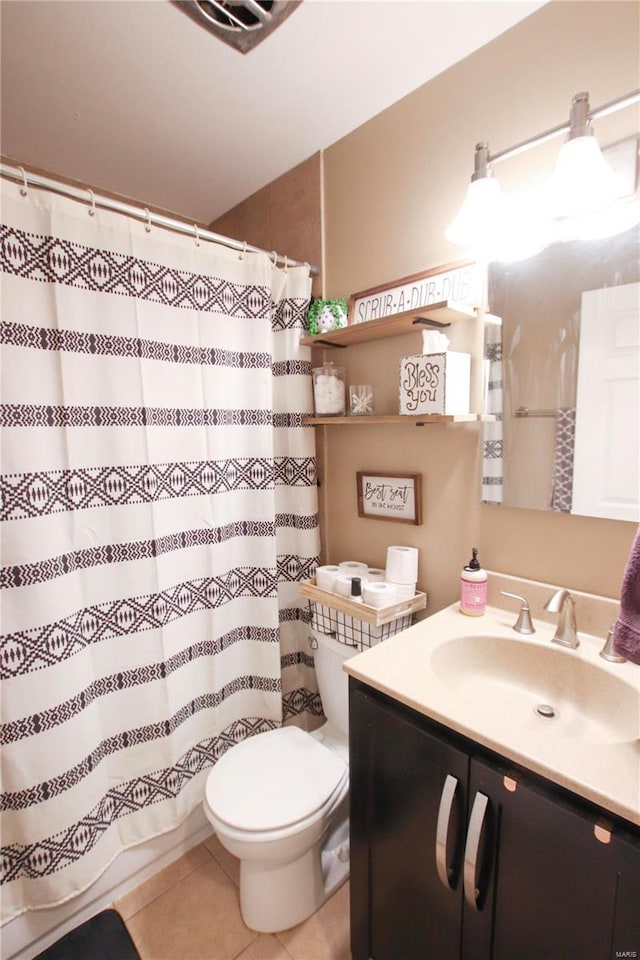 bathroom with toilet, a shower with curtain, vanity, and tile patterned floors