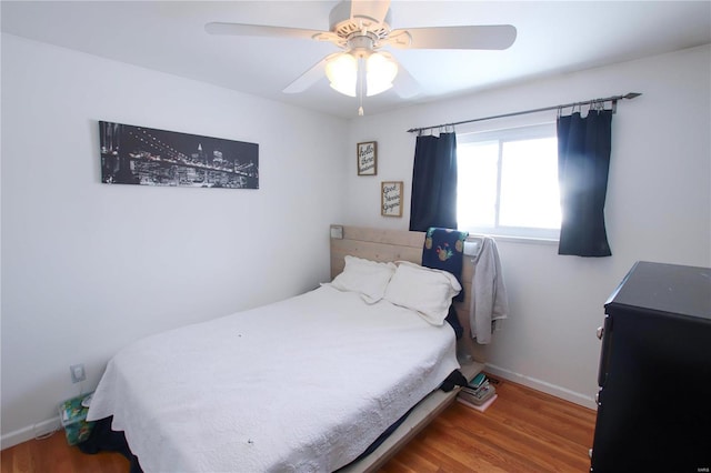 bedroom featuring hardwood / wood-style floors and ceiling fan