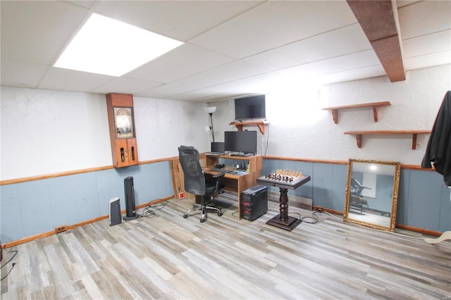 office space with a paneled ceiling and light hardwood / wood-style floors