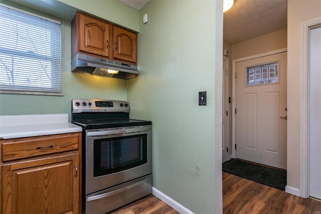 kitchen with dark hardwood / wood-style floors, stainless steel electric range oven, and a textured ceiling