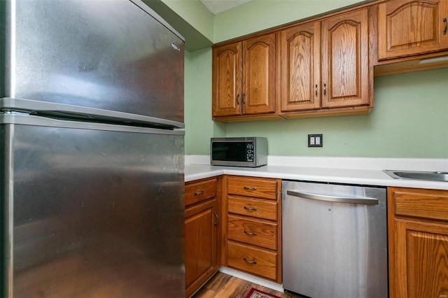 kitchen featuring light wood-type flooring and appliances with stainless steel finishes