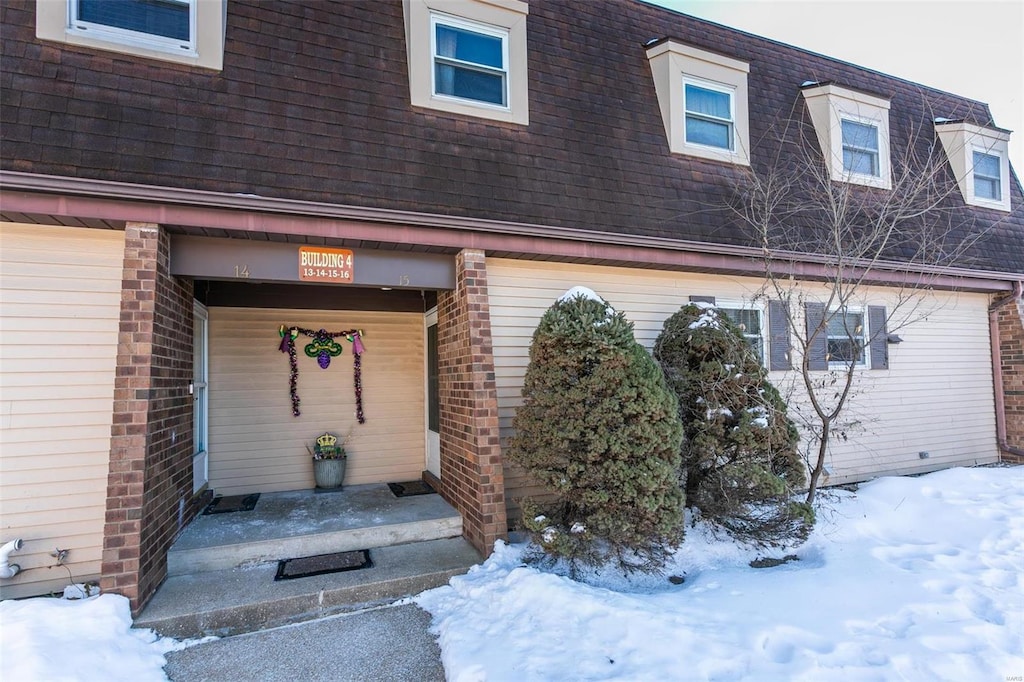 view of snow covered property entrance