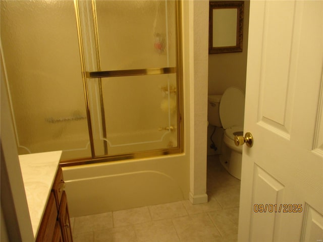 full bathroom featuring tile patterned flooring, vanity, bath / shower combo with glass door, and toilet