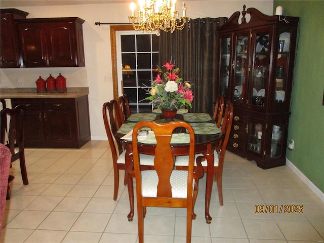 dining space with light tile patterned floors and a notable chandelier