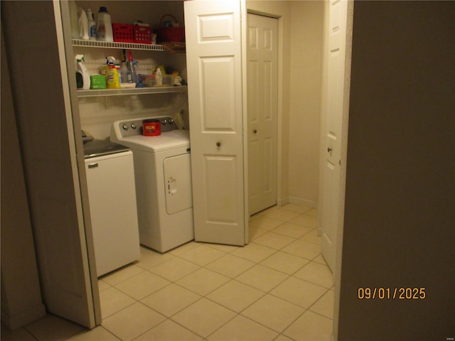 washroom with washer and dryer and light tile patterned floors