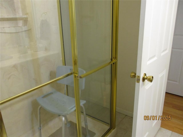 bathroom with tile patterned floors and a shower with shower door