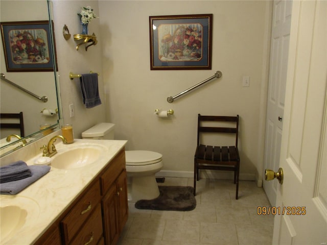 bathroom with tile patterned floors, vanity, and toilet