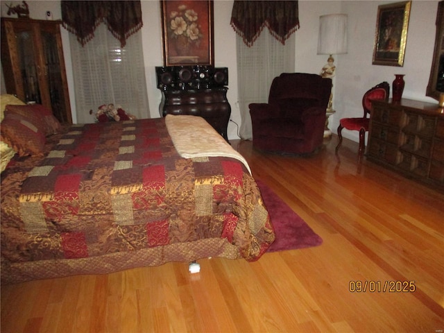 bedroom with hardwood / wood-style flooring