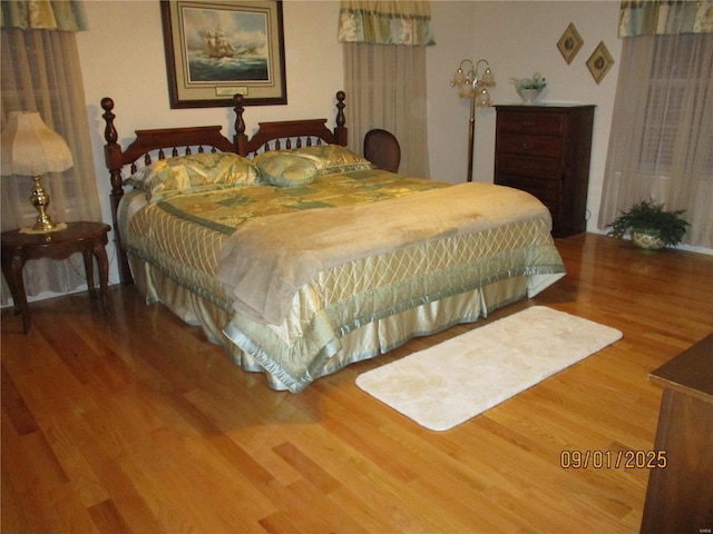 bedroom with hardwood / wood-style flooring