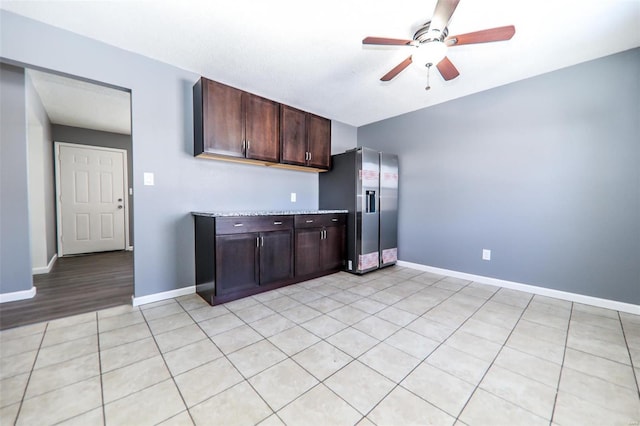 kitchen featuring stainless steel fridge, dark brown cabinetry, and ceiling fan